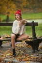 Portrait of a beautiful young Caucasian sensual woman with a red cap ,white pullover and black boots in autumn park Royalty Free Stock Photo