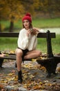 Portrait of a beautiful young Caucasian sensual woman with a red cap ,white pullover and black boots in autumn park Royalty Free Stock Photo