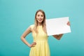 Portrait beautiful young caucasian woman holding a blank paper isolated on pastel blue background Royalty Free Stock Photo