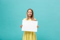 Portrait beautiful young caucasian woman holding a blank paper isolated on pastel blue background Royalty Free Stock Photo