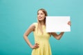 Portrait beautiful young caucasian woman holding a blank paper isolated on pastel blue background Royalty Free Stock Photo