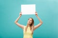 Portrait beautiful young caucasian woman holding a blank paper isolated on pastel blue background Royalty Free Stock Photo