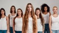 Portrait of beautiful young caucasian woman with long hair in white shirt looking at camera. Group of diverse women Royalty Free Stock Photo