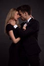 Portrait of young couple in love posing at studio dressed in classic clothes Royalty Free Stock Photo