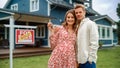 Portrait of a Beautiful Young Couple in Love Standing in Front Their New Home. Successful Homeowners Royalty Free Stock Photo