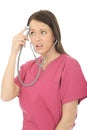 Portrait Of A Beautiful Young Curious Female Doctor Acting Silly with Stethoscope Royalty Free Stock Photo