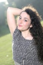 Portrait of a beautiful young curly girl against the light