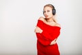 Portrait of a beautiful young DJ girl with headphones in a red Royalty Free Stock Photo