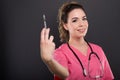 Portrait of beautiful young doctor holding syringe Royalty Free Stock Photo