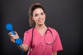 Portrait of beautiful young doctor holding telephone receiver Royalty Free Stock Photo