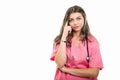 Portrait of beautiful young doctor wearing scrubs making thinking position Royalty Free Stock Photo