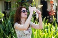 Portrait of a beautiful young exited european girl in taking selfie using phone