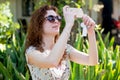 Portrait of a beautiful young exited european woman in taking selfie using phone