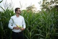 Portrait of a beautiful young farmer & x28;student& x29; working in the field, happy, in a shirt, corn field. Concept