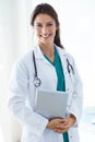 Beautiful young female doctor looking at camera in the office. Royalty Free Stock Photo