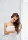 Portrait Of Beautiful Young Female Model  in  Bath Applying Hair Oil. Closeup Of Sexy Woman In Towel Drying Wet Long Hair. Health Royalty Free Stock Photo