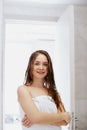 Portrait Of Beautiful Young Female Model  in  Bath Applying Hair Oil. Closeup Of Sexy Woman In Towel Drying Wet Long Hair. Royalty Free Stock Photo