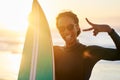 Come get your surf on. Portrait of a beautiful young female surfer posing with her surfboard at the beach. Royalty Free Stock Photo