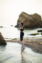 Portrait of beautiful young female tourist photographer with camera at sea Royalty Free Stock Photo