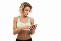 Portrait of beautiful young fit girl texting on smartphone Royalty Free Stock Photo