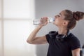 Portrait of beautiful young fit woman drinking water during traning in the gym Royalty Free Stock Photo