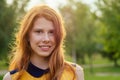 Portrait of beautiful young ginger redhead irish woman in a yellow dress stylish makeup and fresh toothy smile in the Royalty Free Stock Photo