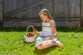 Portrait of beautiful young girl with basket of strawberries.