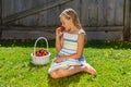 Portrait of beautiful young girl with basket of strawberries.