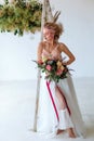 Portrait of a beautiful young girl with a bouquet that creates a wedding dress Royalty Free Stock Photo