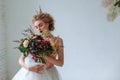 Portrait of a beautiful young girl with a bouquet that creates a wedding dress Royalty Free Stock Photo