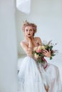 Portrait of a beautiful young girl with a bouquet that creates a wedding dress Royalty Free Stock Photo