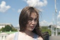 Portrait of beautiful young girl with blowing hair in wind in the city blue sky background Royalty Free Stock Photo