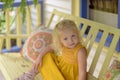 Beautiful child on porch swing in summer Royalty Free Stock Photo