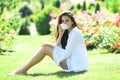 Portrait of a beautiful young girl drinks morning coffee or tea in the spring yard. Royalty Free Stock Photo