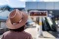 portrait of a beautiful and young girl in a hat at the railway station. A young woman in a coat and hat stands at the station and