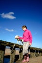 Portrait of a beautiful young girl and her puppy doing balance exercises on the beac