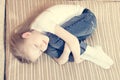 Portrait of beautiful young girl laying on bed hugging herself smiling eyes closed & dreaming Royalty Free Stock Photo