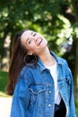 Portrait of beautiful young girl posing in summer park. Majestic woman`s beauty. Youth, happiness