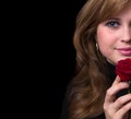 Portrait of a beautiful young girl with a red rose in her hand Royalty Free Stock Photo