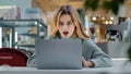 Portrait beautiful young girl student business woman female user winner looking into laptop surprised wide open mouth Royalty Free Stock Photo