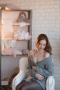 Portrait of a beautiful young girl in a white knit sweater, winter, comfort, warmth, lifestyle, hair, makeup Royalty Free Stock Photo