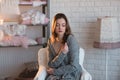 Portrait of a beautiful young girl in a white knit sweater, winter, comfort, warmth, lifestyle, hair, makeup Royalty Free Stock Photo