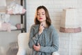 Portrait of a beautiful young girl in a white knit sweater, winter, comfort, warmth, lifestyle, hair, makeup Royalty Free Stock Photo