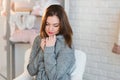 Portrait of a beautiful young girl in a white knit sweater, winter, comfort, warmth, lifestyle, hair, makeup Royalty Free Stock Photo