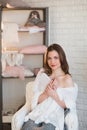 Portrait of a beautiful young girl in a white knit sweater, winter, comfort, warmth, lifestyle, hair, makeup Royalty Free Stock Photo