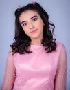 Portrait Of Beautiful Young girle Standing Against blue Background,girl in a pink dress,Happy cheery smiling young cute girl