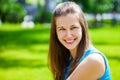 Portrait of beautiful young happy brunette woman with fresh and clean skin, summer street outdoors Royalty Free Stock Photo