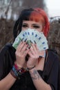 Portrait of a beautiful young individual, eccentric woman, is enjoying many euro bills Royalty Free Stock Photo