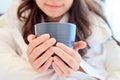 Portrait of a beautiful young lady drinking her morning coffee in her bedroom Royalty Free Stock Photo