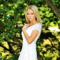 Portrait of a beautiful young lady in summer green park Royalty Free Stock Photo